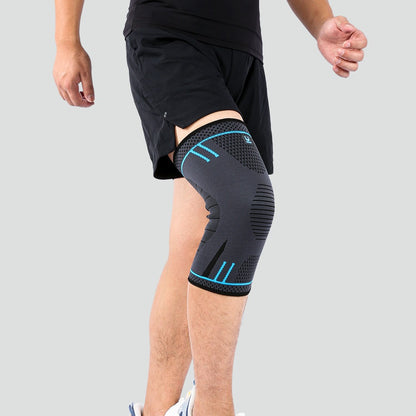 Person wearing a black knee brace with blue accents on a gray background