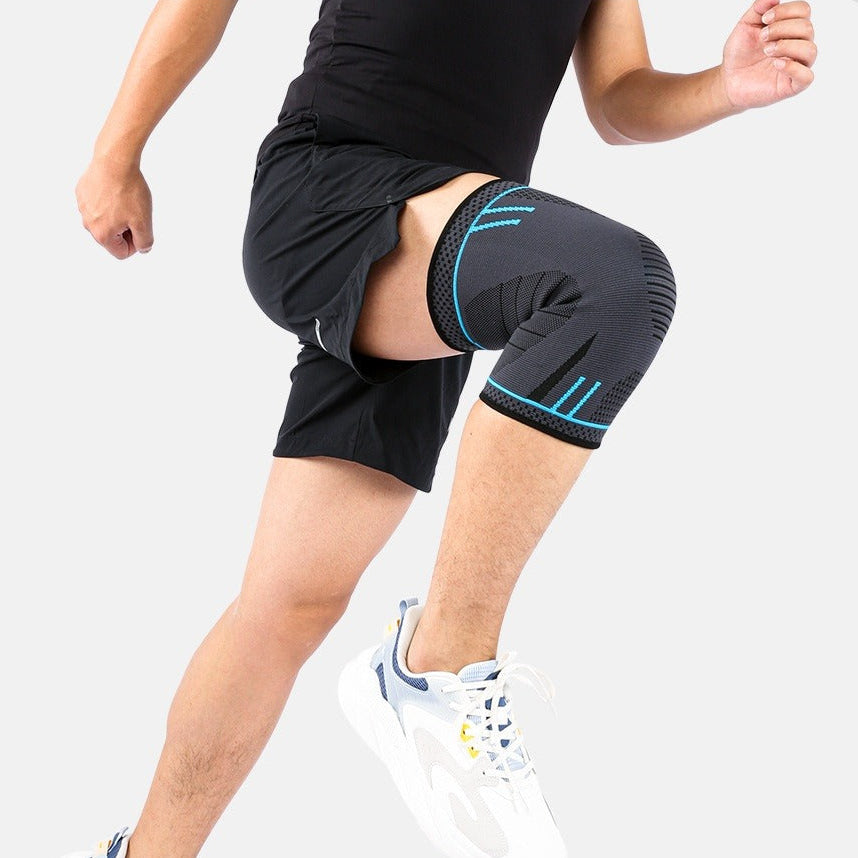 Person wearing a black knee brace on a white background